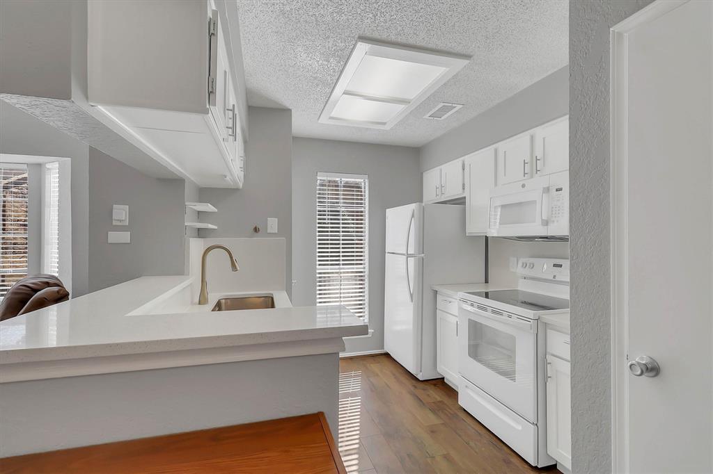 14333 Preston Road, Unit 2103 Dallas, TX 75254 - Photo 11 of 19 a kitchen with appliances a sink and cabinets