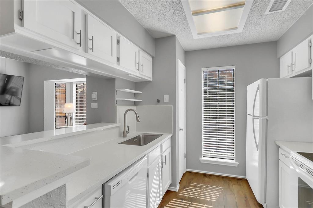 14333 Preston Road, Unit 2103 Dallas, TX 75254 - Photo 12 of 19 a kitchen with stainless steel appliances a sink a refrigerator and cabinets