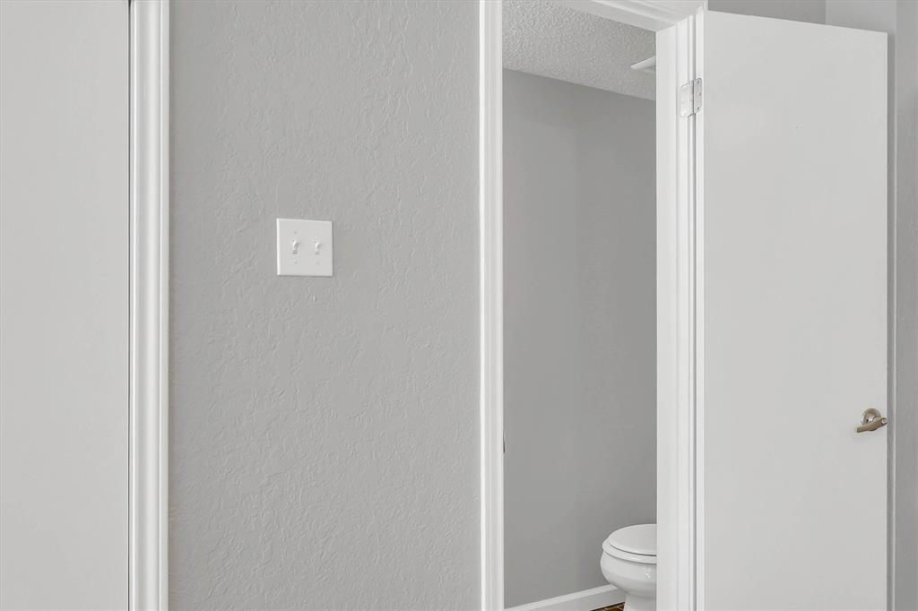 14333 Preston Road, Unit 2103 Dallas, TX 75254 - Photo 13 of 19 a white toilet sitting next to a shower