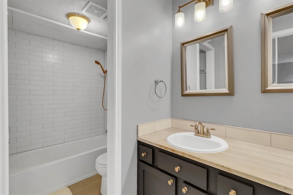 14333 Preston Road, Unit 2103 Dallas, TX 75254 - Photo 15 of 19 a bathroom with a sink toilet a vanity and shower