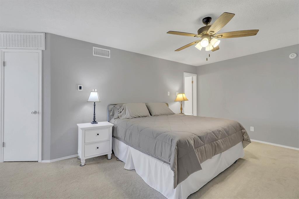 14333 Preston Road, Unit 2103 Dallas, TX 75254 - Photo 17 of 19 a bedroom with a bed and a chandelier
