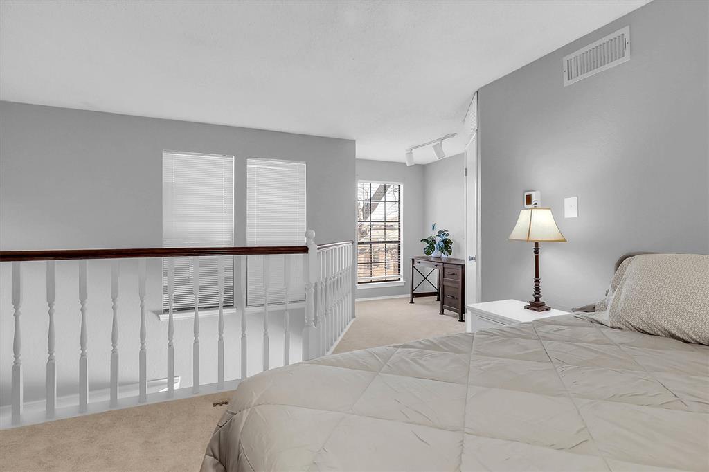 14333 Preston Road, Unit 2103 Dallas, TX 75254 - Photo 18 of 19 a bed room with a bed and a lamp