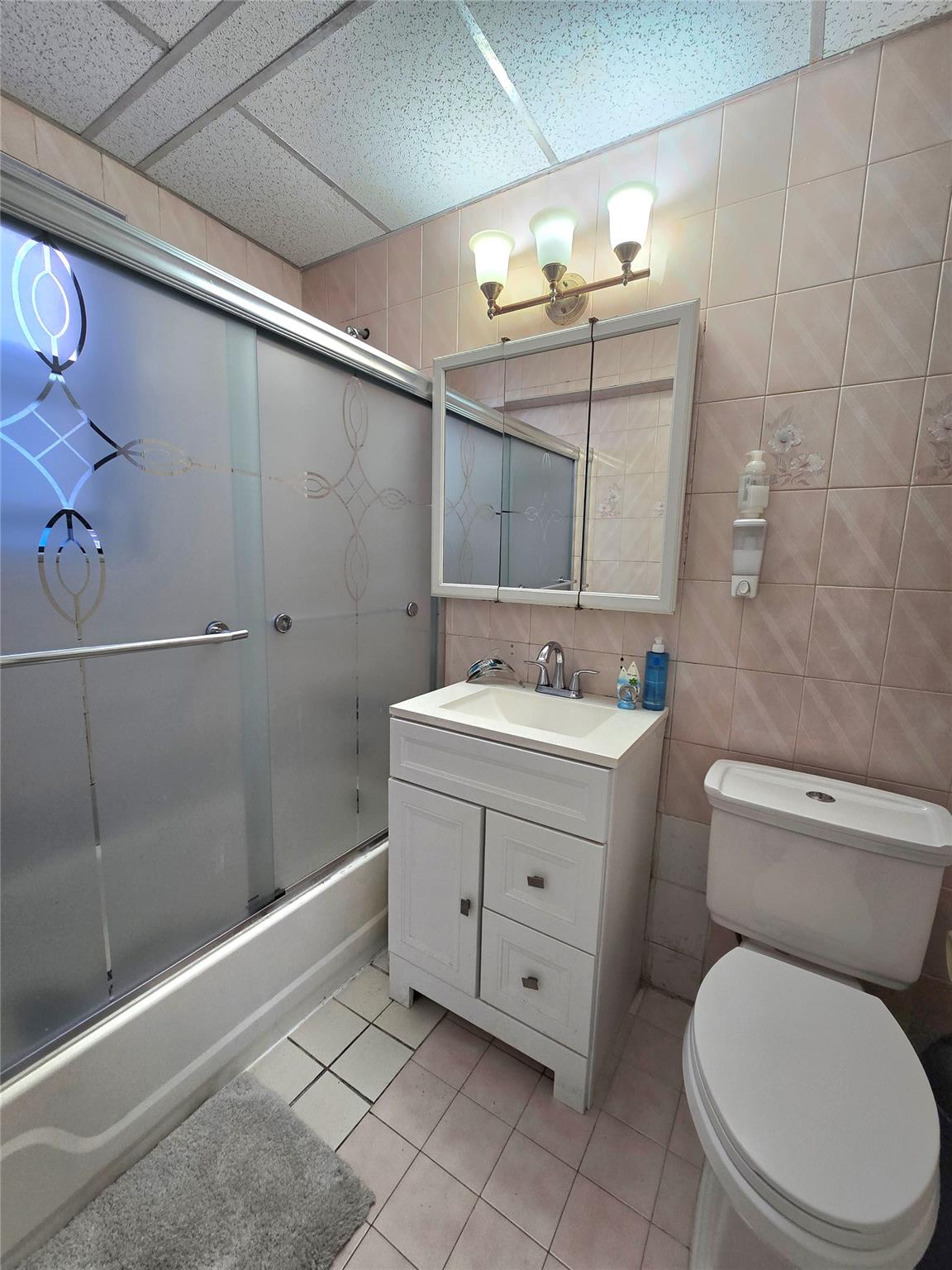 131-11 Kew Gardens Road, Unit 5F Queens, NY 11418 - Photo 5 of 9 a bathroom with a toilet sink vanity and mirror