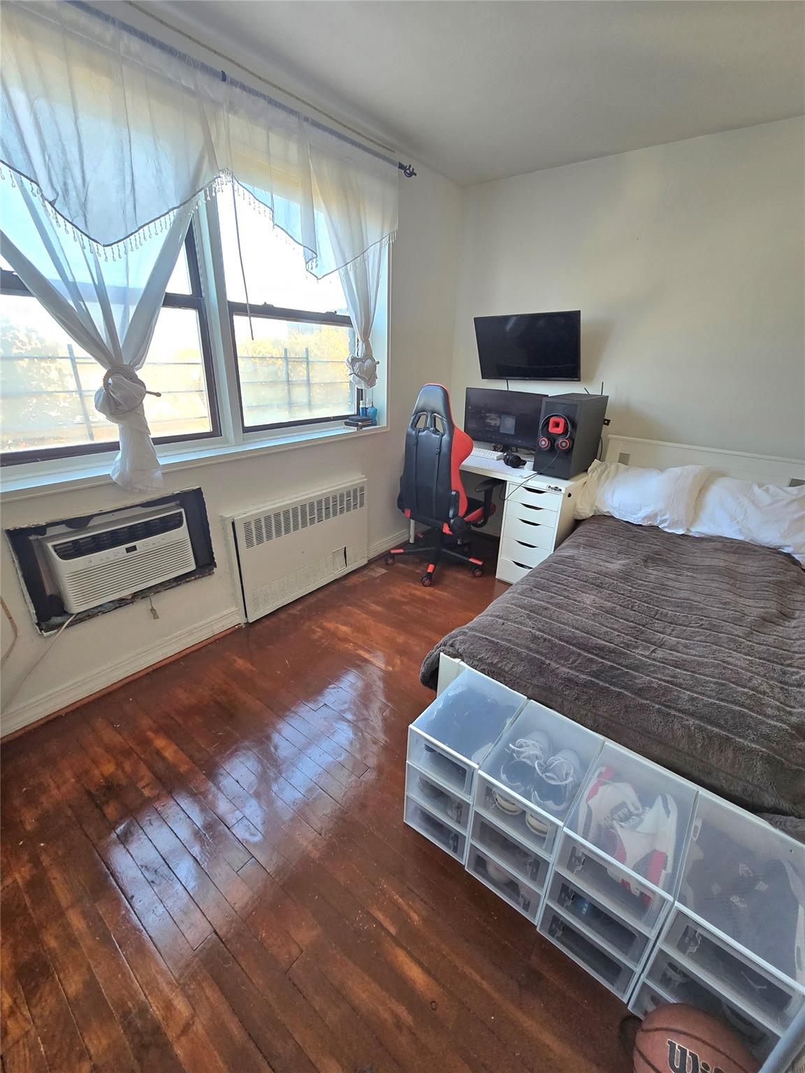 131-11 Kew Gardens Road, Unit 5F Queens, NY 11418 - Photo 7 of 9 a bedroom with a bed and flat tv screen on the dresser