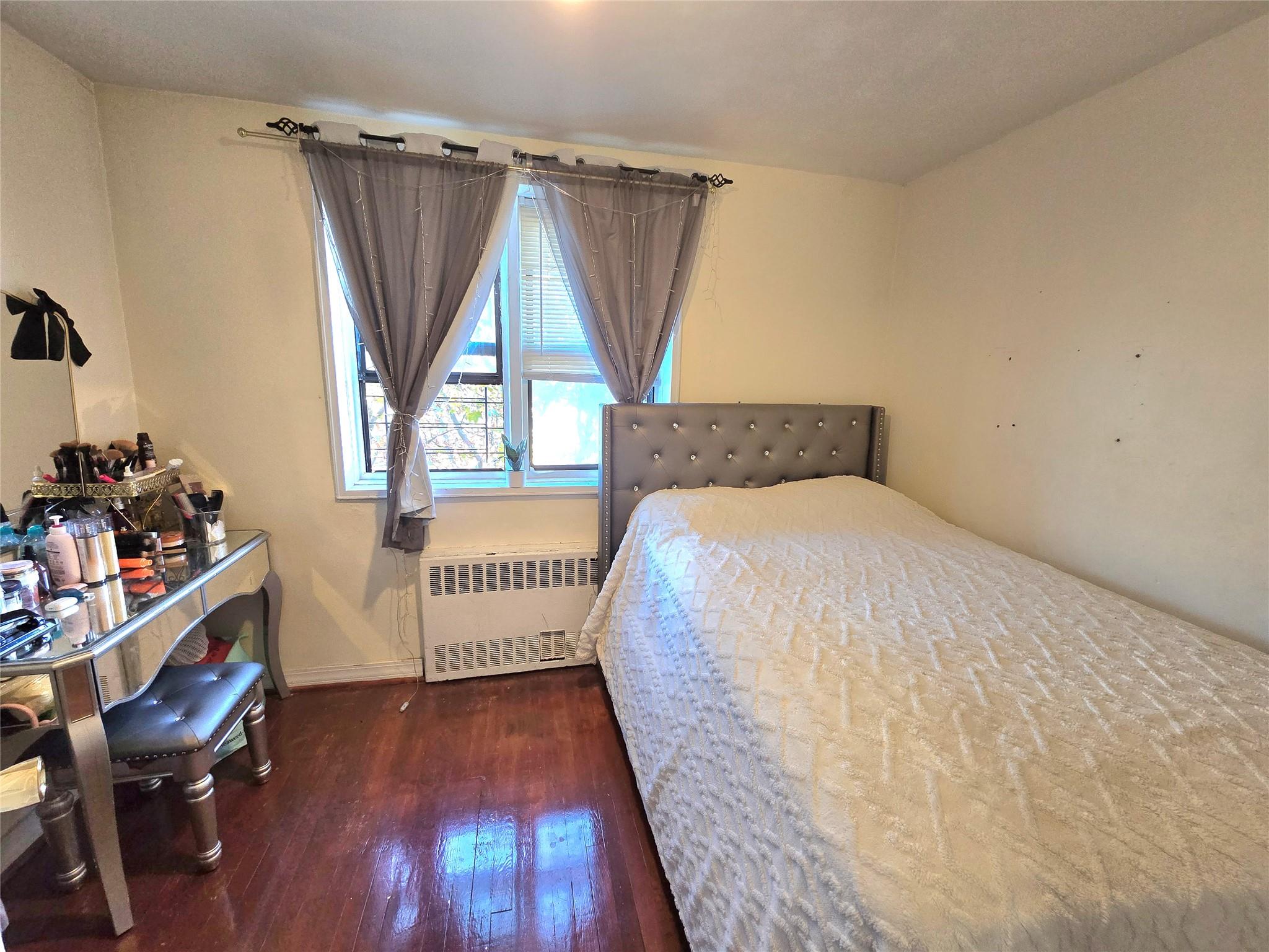131-11 Kew Gardens Road, Unit 5F Queens, NY 11418 - Photo 8 of 9 a spacious bedroom with a bed and a window