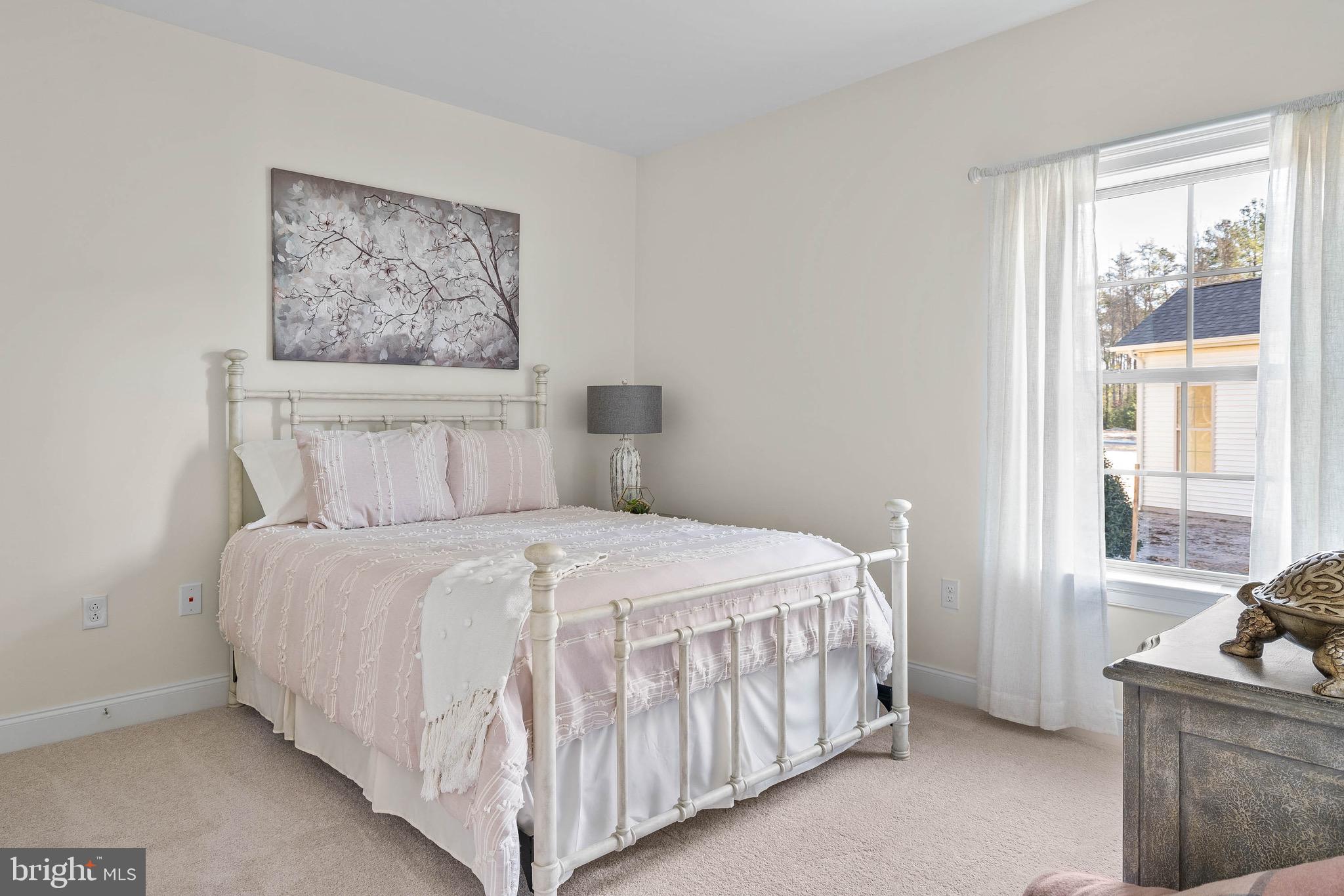 22544 Hummingbird Road Ellendale, DE 19941 - Photo 20 of 32 a bedroom with a bed and glass windows