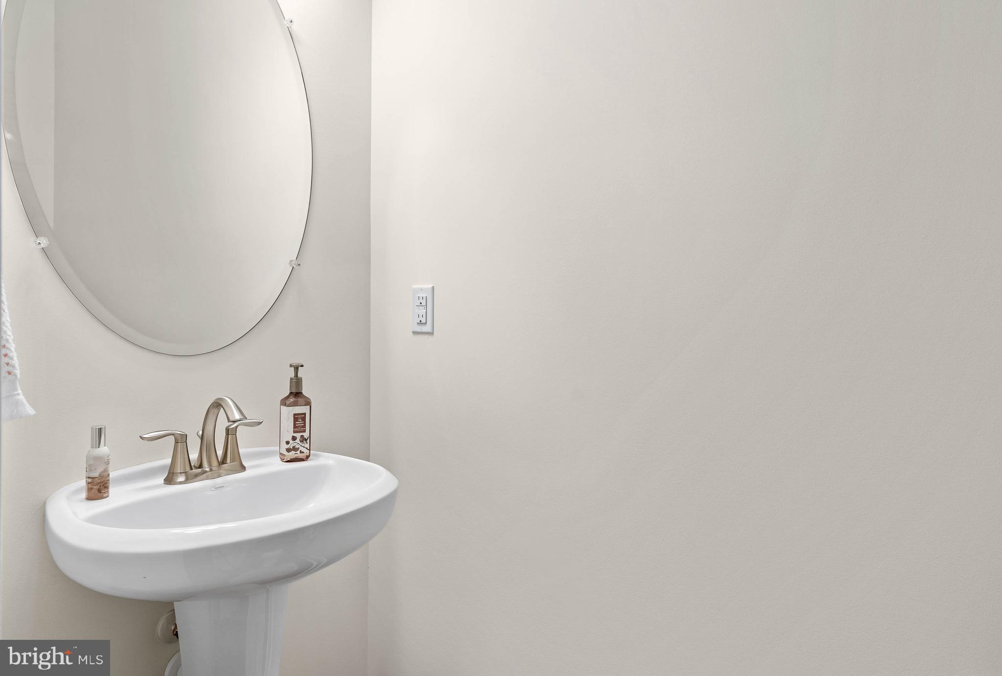 22544 Hummingbird Road Ellendale, DE 19941 - Photo 29 of 32 a bathroom with a sink a mirror and a toilet
