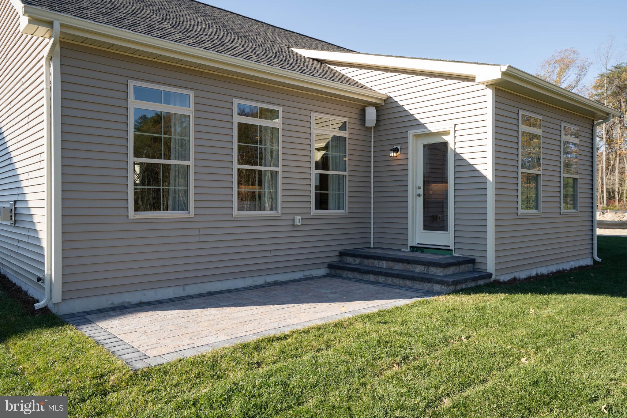 22544 Hummingbird Road Ellendale, DE 19941 - Photo 32 of 32 a view of a house with a small yard and a large window