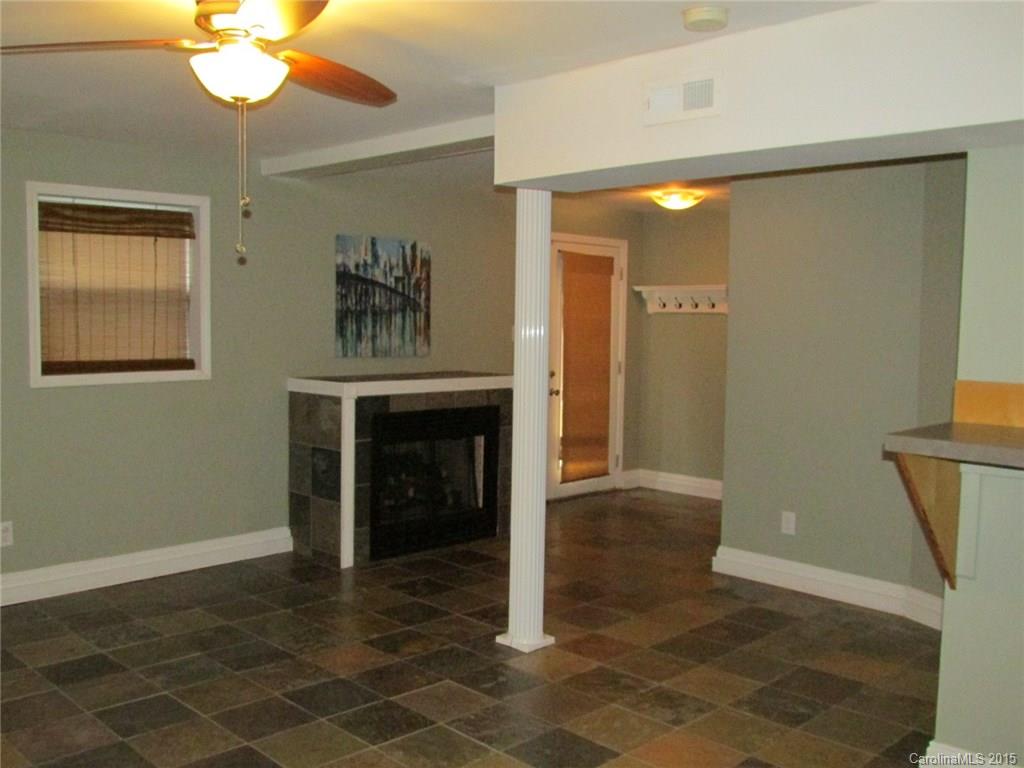 1310 West Ridge Road Salisbury, NC 28147 - Photo 22 of 24 a view of a hallway with a chandelier and a fireplace