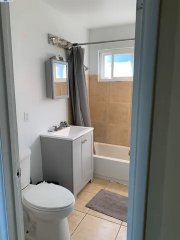 a white refrigerator freezer and a stove sitting inside of a kitchen