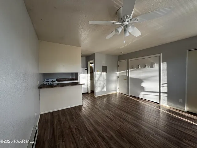 a kitchen with a refrigerator and a stove top oven