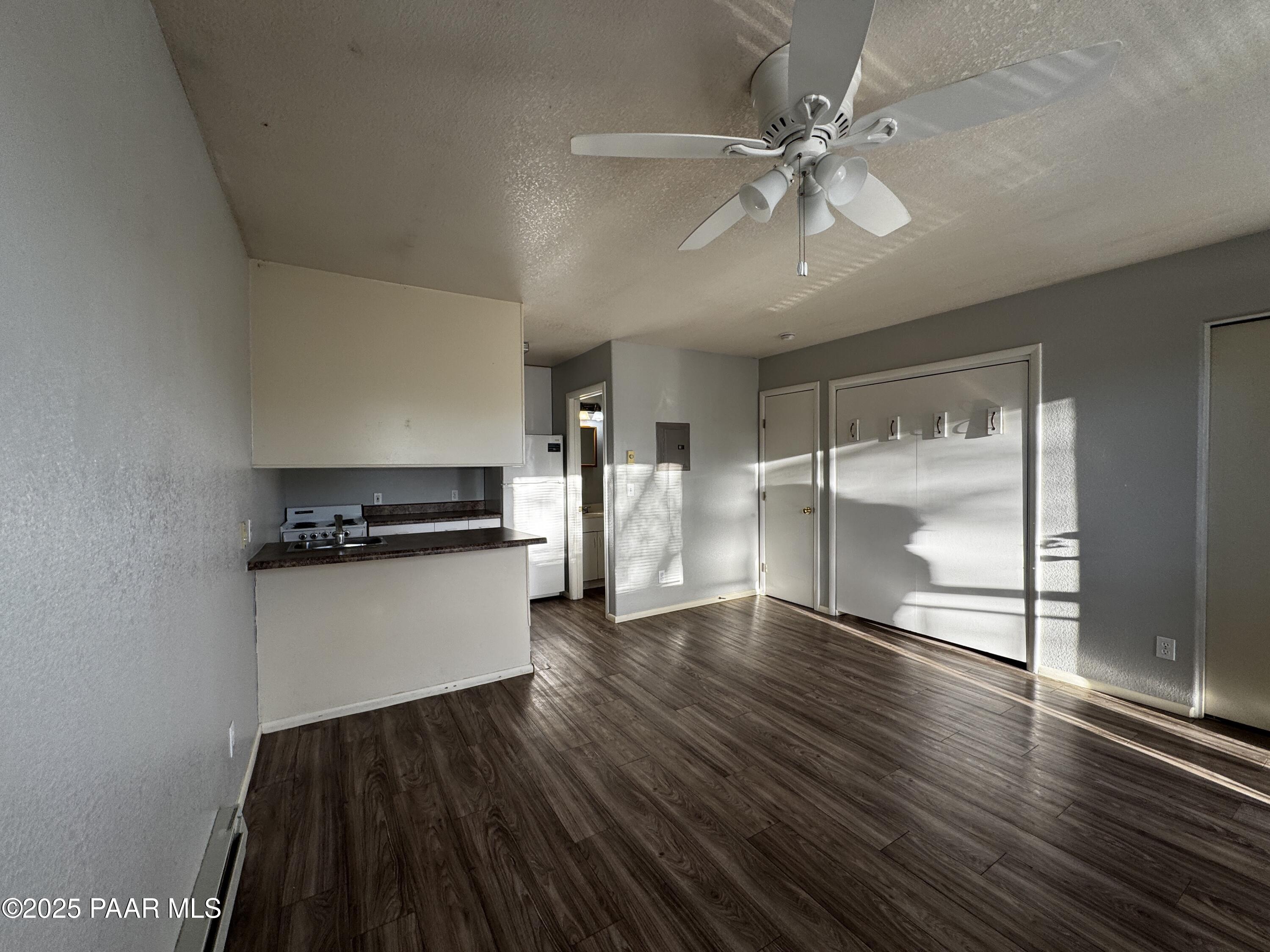 4873 North Judy Court, Unit C Prescott Valley, AZ 86314 - Photo 3 of 6 a kitchen with a refrigerator and a stove top oven