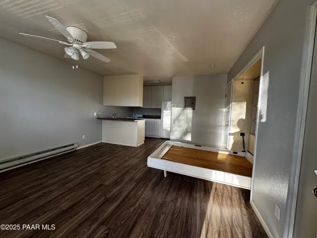 a view of living room with wooden floor and ceiling fan