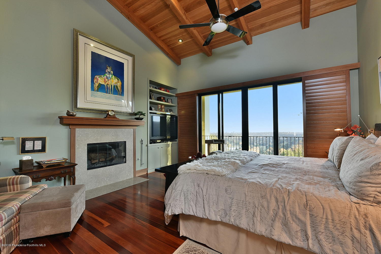 1825 Braemar Road Pasadena, CA 91103 - Photo 32 of 82 a spacious bedroom with a balcony a bed and a fireplace