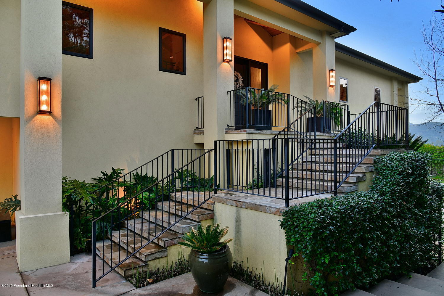 1825 Braemar Road Pasadena, CA 91103 - Photo 57 of 82 a view of a house with large windows and flower plants