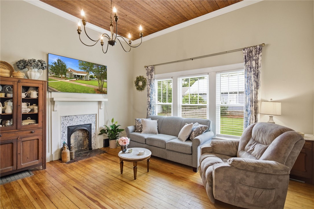 314 South Fairplay Street Seneca, SC 29678 - Photo 8 of 50 This inviting living room boasts warm hardwood flooring and a charming fireplace, perfect for cozy gatherings.