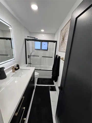 a bathroom with 2 sink and a mirror