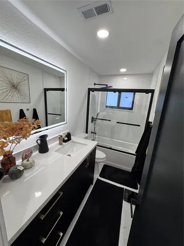 a kitchen with a refrigerator and cabinets