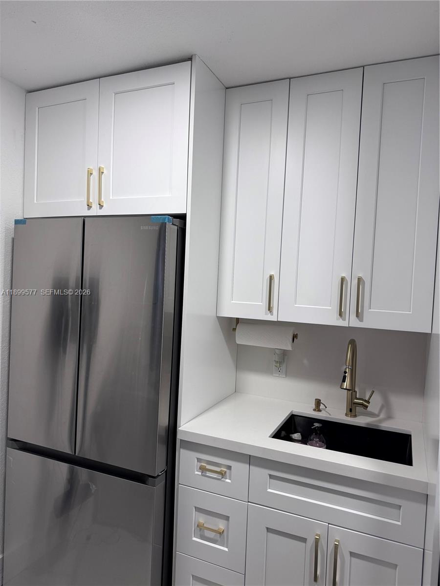 26711 Southwest 145th Avenue Road Homestead, FL 33032 - Photo 13 of 21 a kitchen with a refrigerator and cabinets