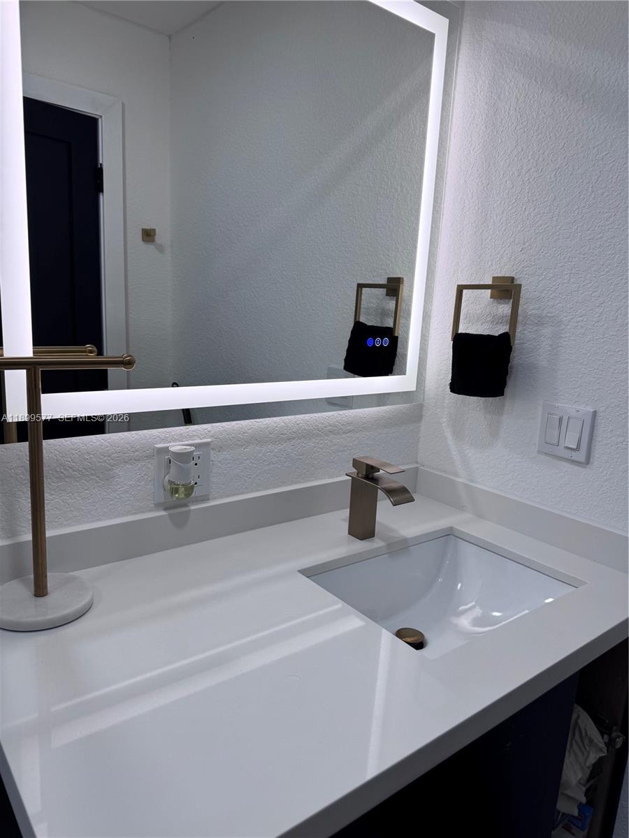 26711 Southwest 145th Avenue Road Homestead, FL 33032 - Photo 16 of 21 a bathroom with a sink and a mirror