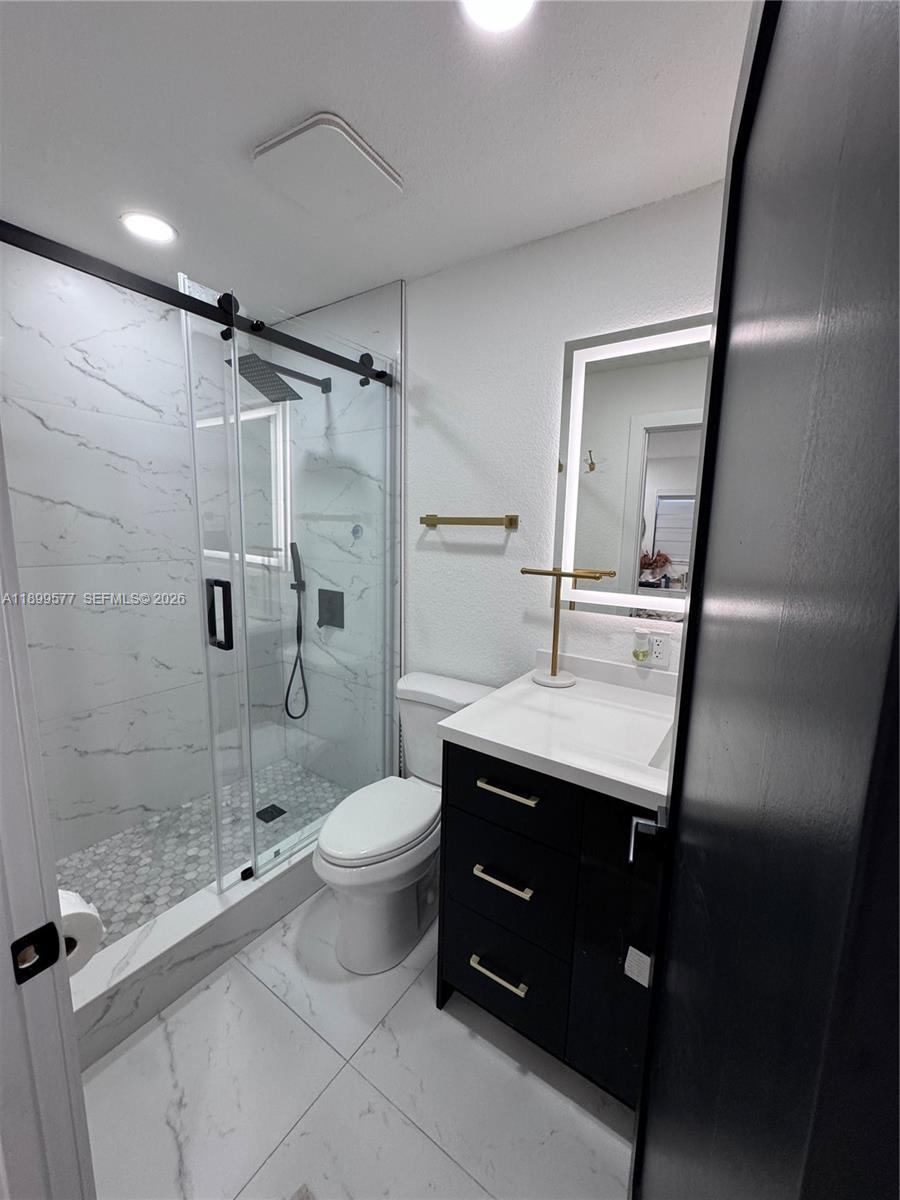 26711 Southwest 145th Avenue Road Homestead, FL 33032 - Photo 17 of 21 a bathroom with a sink toilet and shower