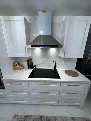 a kitchen with a stove and cabinets