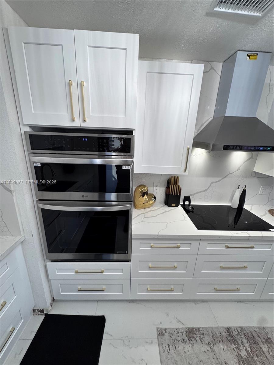 26711 Southwest 145th Avenue Road Homestead, FL 33032 - Photo 7 of 21 a kitchen with a stove and cabinets