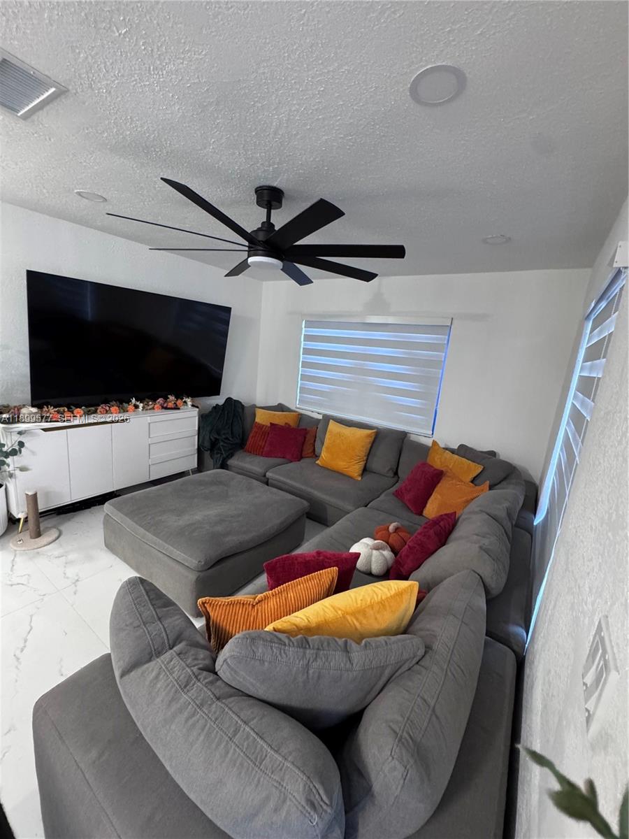 26711 Southwest 145th Avenue Road Homestead, FL 33032 - Photo 9 of 21 a living room with furniture and a flat screen tv