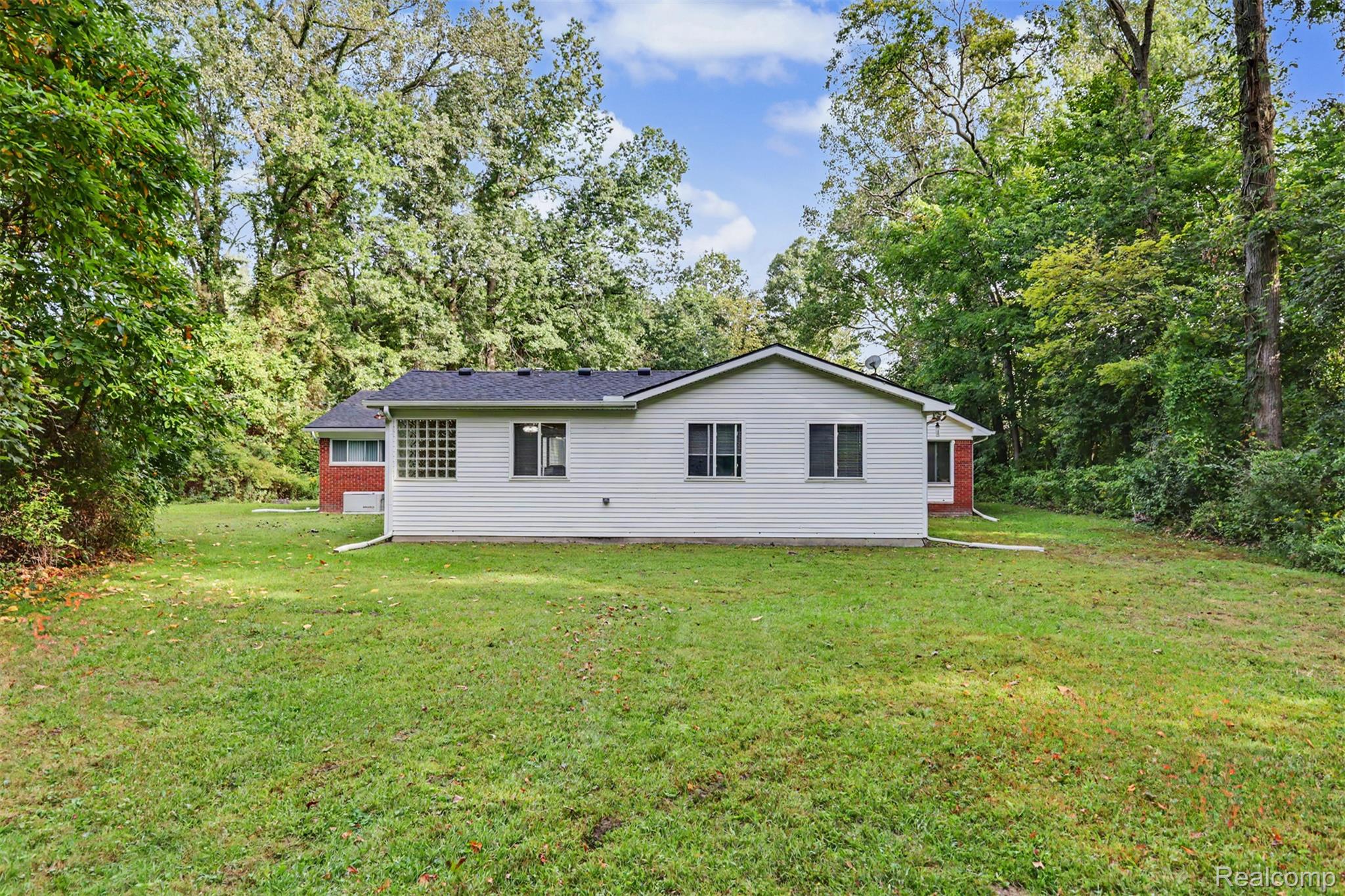 45223 Wear Road Belleville, MI 48111 - Photo 48 of 60 Expansive backyard with a lush lawn and mature trees