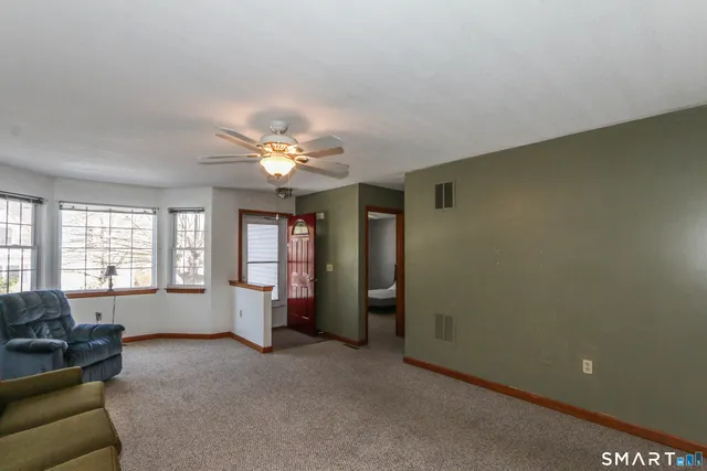 a living room with furniture and chandelier