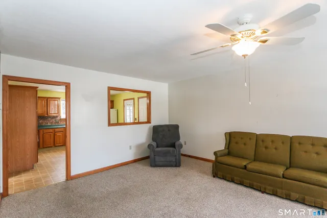 a living room with furniture and a chandelier