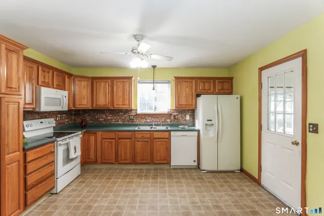 a kitchen with stainless steel appliances granite countertop cabinets and a refrigerator