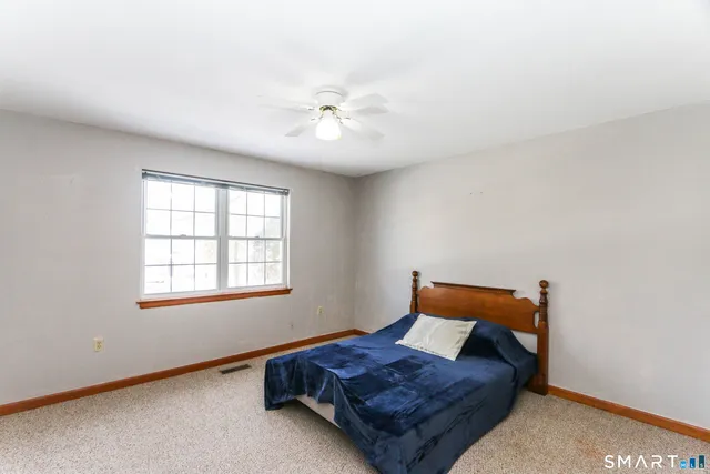 a living room with a bed and a window