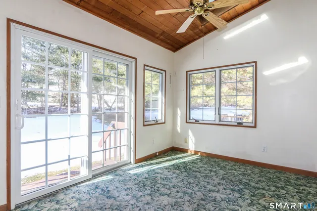 a view of a livingroom with a ceiling fan and window