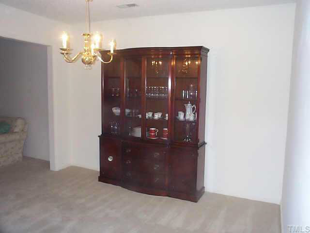 728 Red Forest Trail Raleigh, NC 27615 - Photo 4 of 8 a view of a dining room with wooden floor