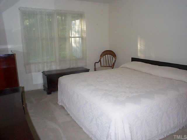 728 Red Forest Trail Raleigh, NC 27615 - Photo 7 of 8 a bedroom with a bed and a window