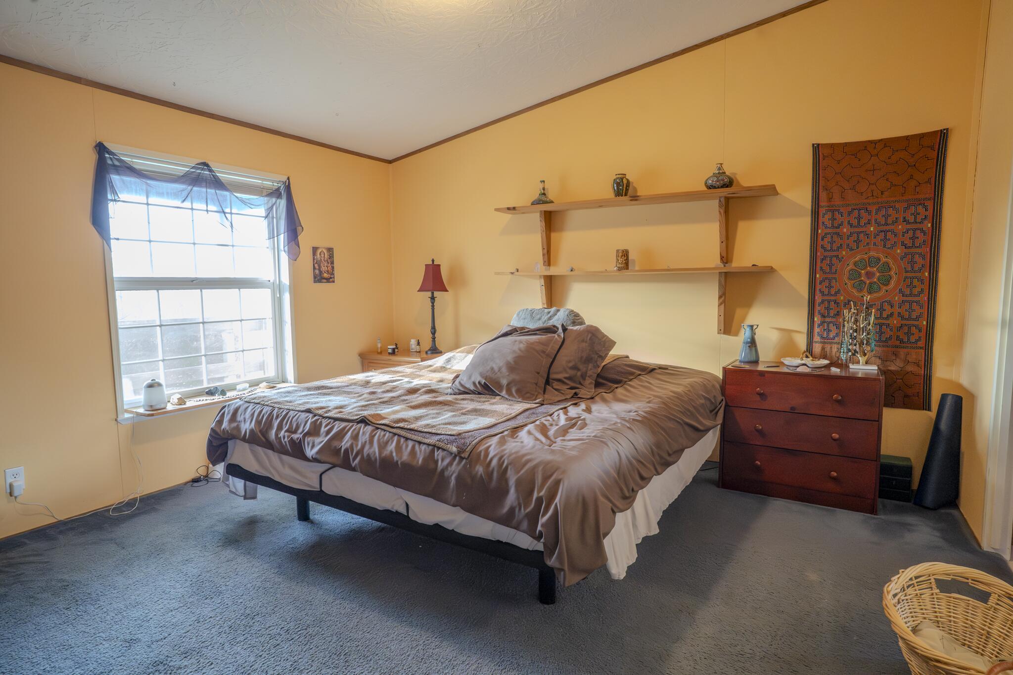 362 Humbug Creek Road Jacksonville, OR 97530 - Photo 13 of 49 a bedroom with a bed dresser and a window