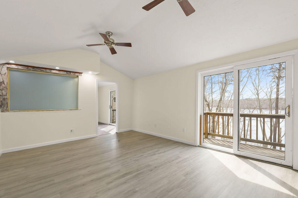 75 Edgewater Road Mashpee, MA 02649 - Photo 39 of 78 an empty room with wooden floor and windows