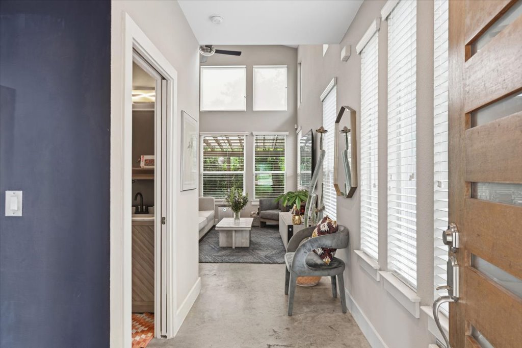 1800 Webberville Road, Unit B Austin, TX 78721 - Photo 5 of 30 Entryway featuring a solid wood door with horizontal glass insets, polished concrete flooring, and an open concept layout
