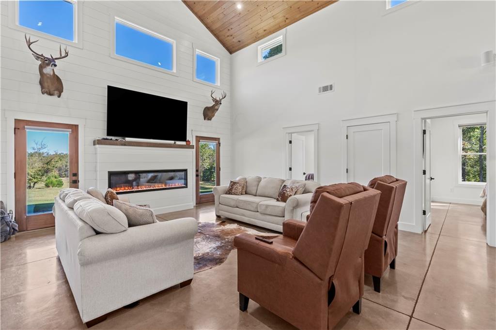 196 Frank Brown Road Maysville, GA 30558 - Photo 40 of 66 a living room with furniture a flat screen tv and a fireplace