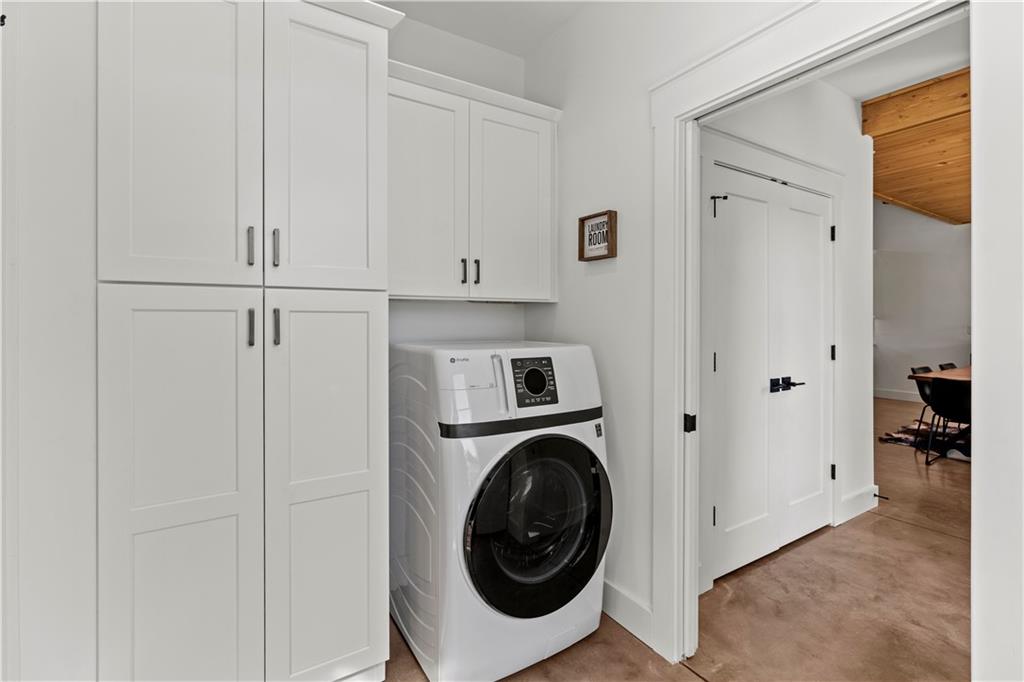 196 Frank Brown Road Maysville, GA 30558 - Photo 45 of 66 a view of a storage and utility room with washer and dryer