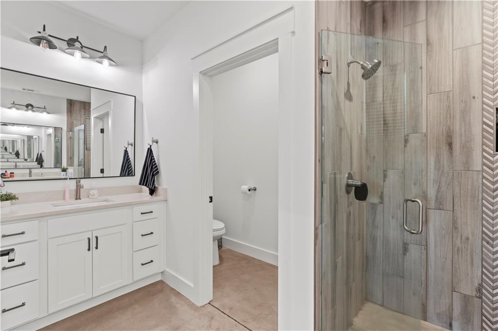196 Frank Brown Road Maysville, GA 30558 - Photo 50 of 66 a bathroom with a double vanity sink and mirror