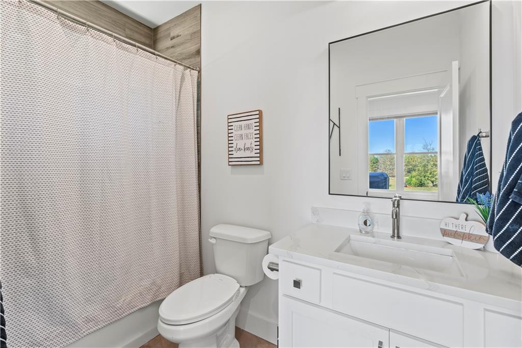 196 Frank Brown Road Maysville, GA 30558 - Photo 56 of 66 a bathroom with a sink a toilet and shower curtain