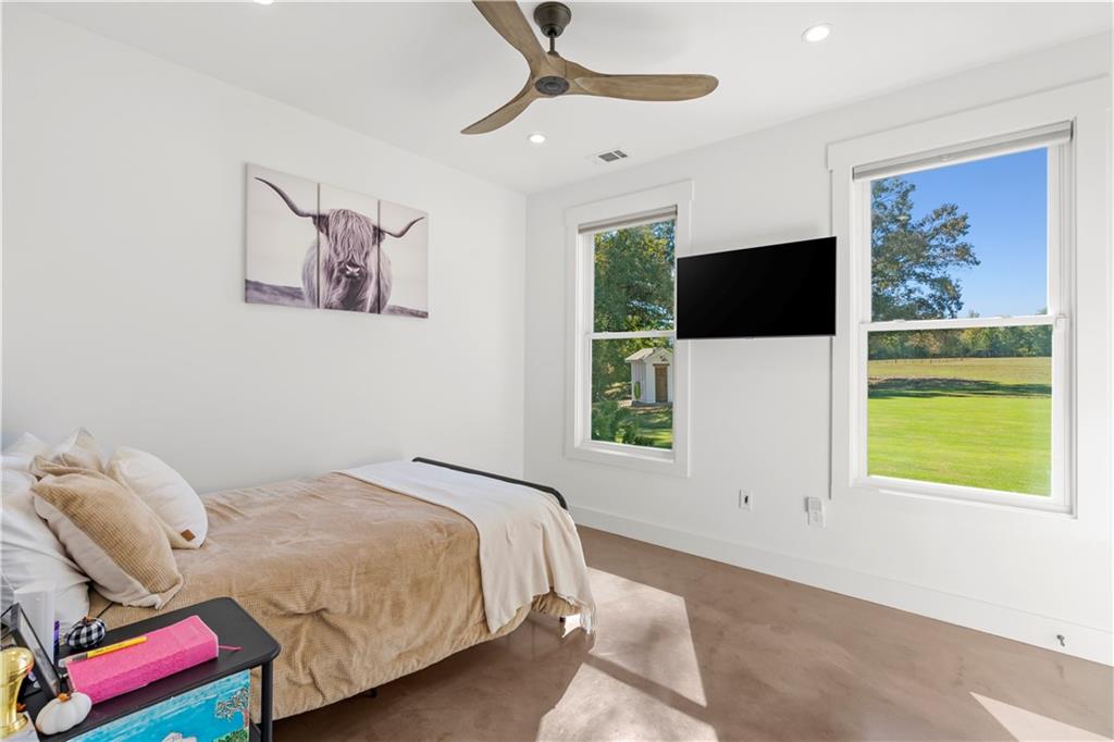 196 Frank Brown Road Maysville, GA 30558 - Photo 58 of 66 a bedroom with a bed and a flat screen tv