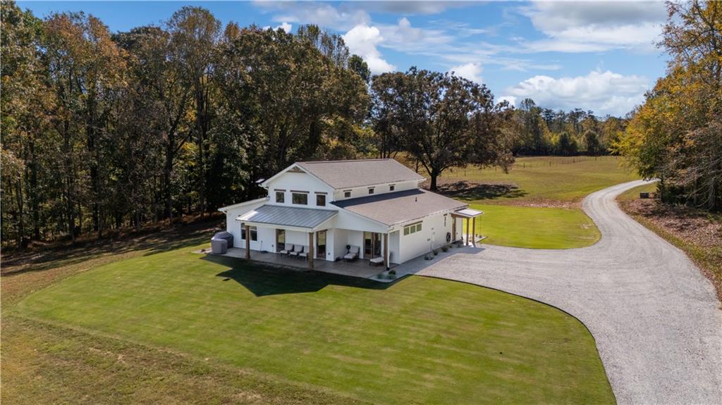196 Frank Brown Road Maysville, GA 30558 - Photo 9 of 66 an aerial view of a house with swimming pool and large trees