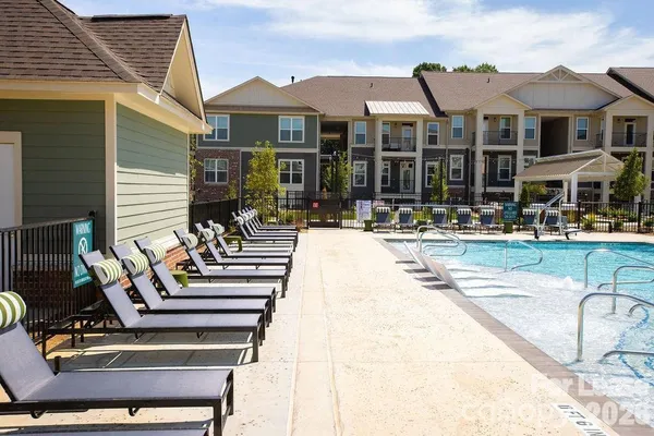 a building outdoor space with patio furniture and potted plants