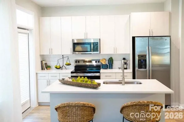 a kitchen with sink refrigerator and stove