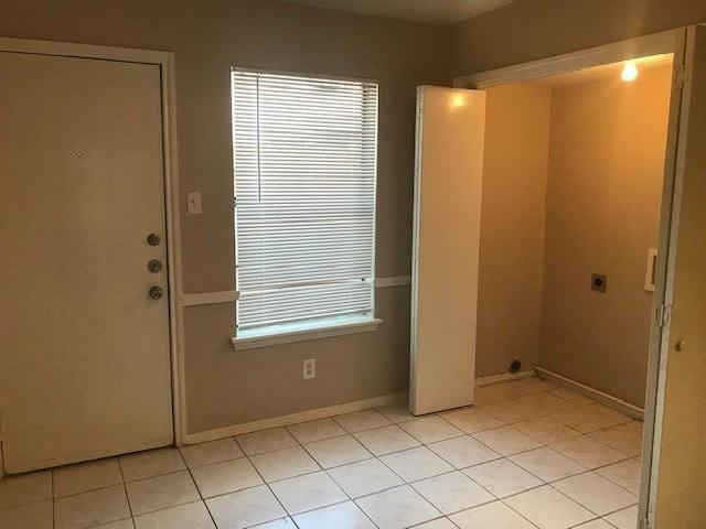8005 Rothington Road, Unit 53 Dallas, TX 75227 - Photo 5 of 11 Washroom featuring electric dryer hookup and light tile patterned floors