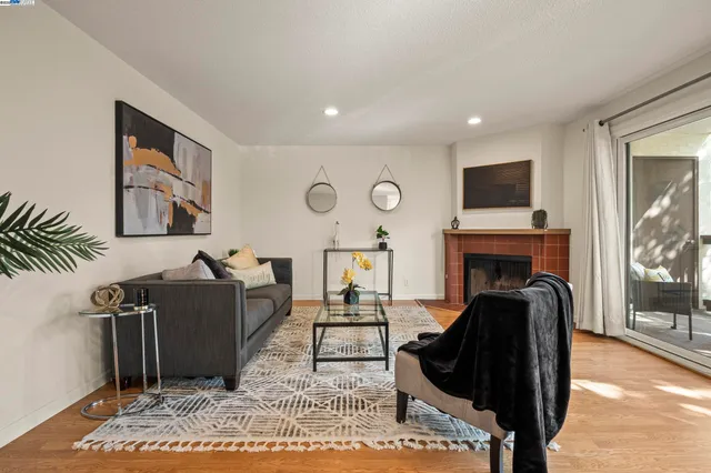 a living room with furniture a fireplace and a flat screen tv