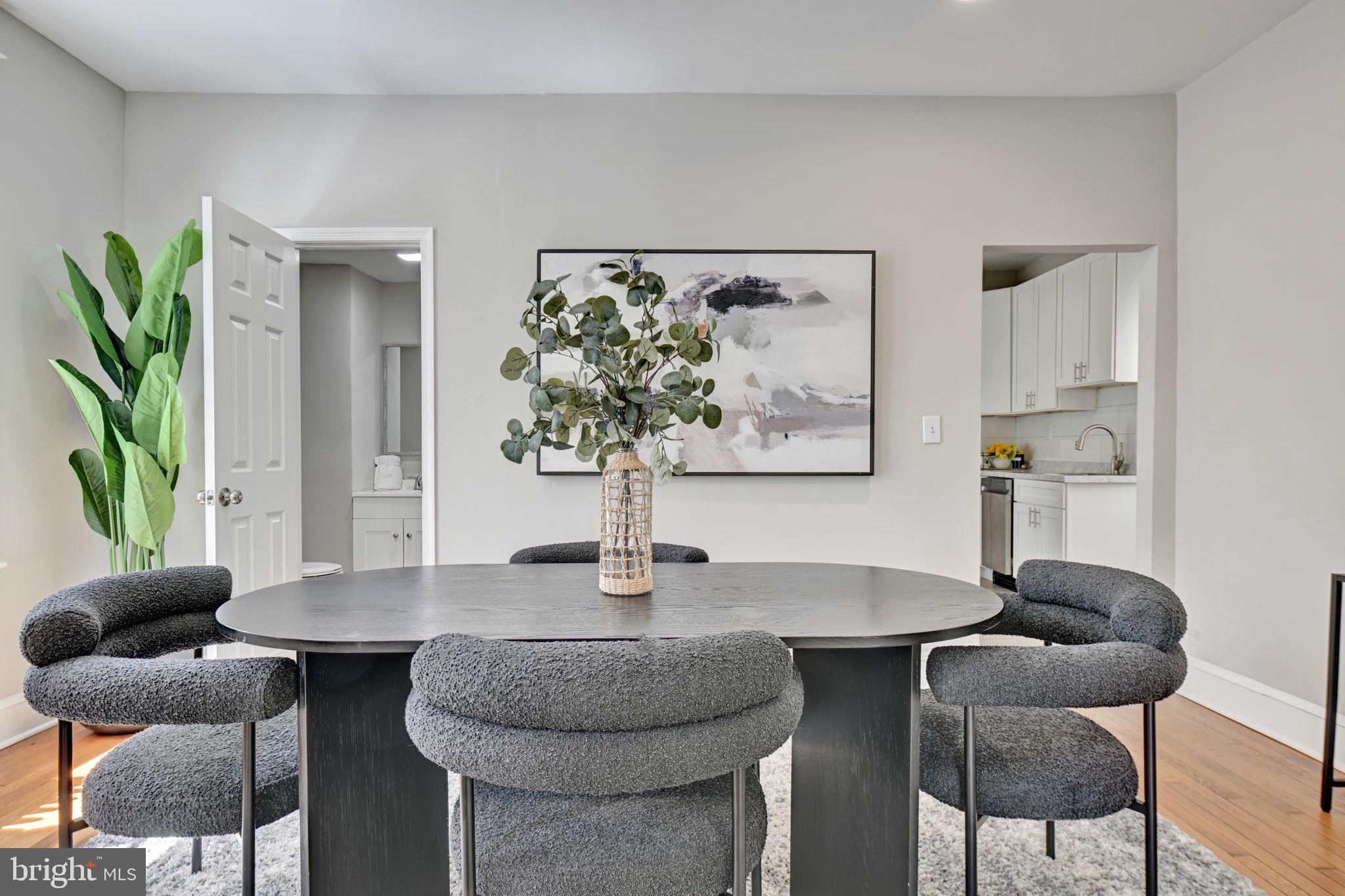 3005 7th Street Southeast Washington, DC 20032 - Photo 15 of 56 a dining room with furniture and a potted plant